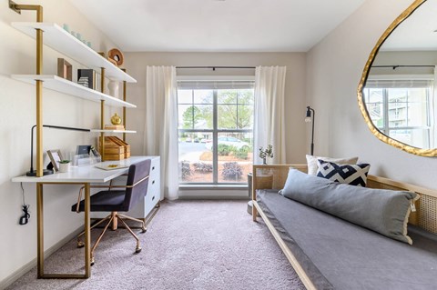 a bedroom with a bed and a desk and a window at Ashford Green, North Carolina